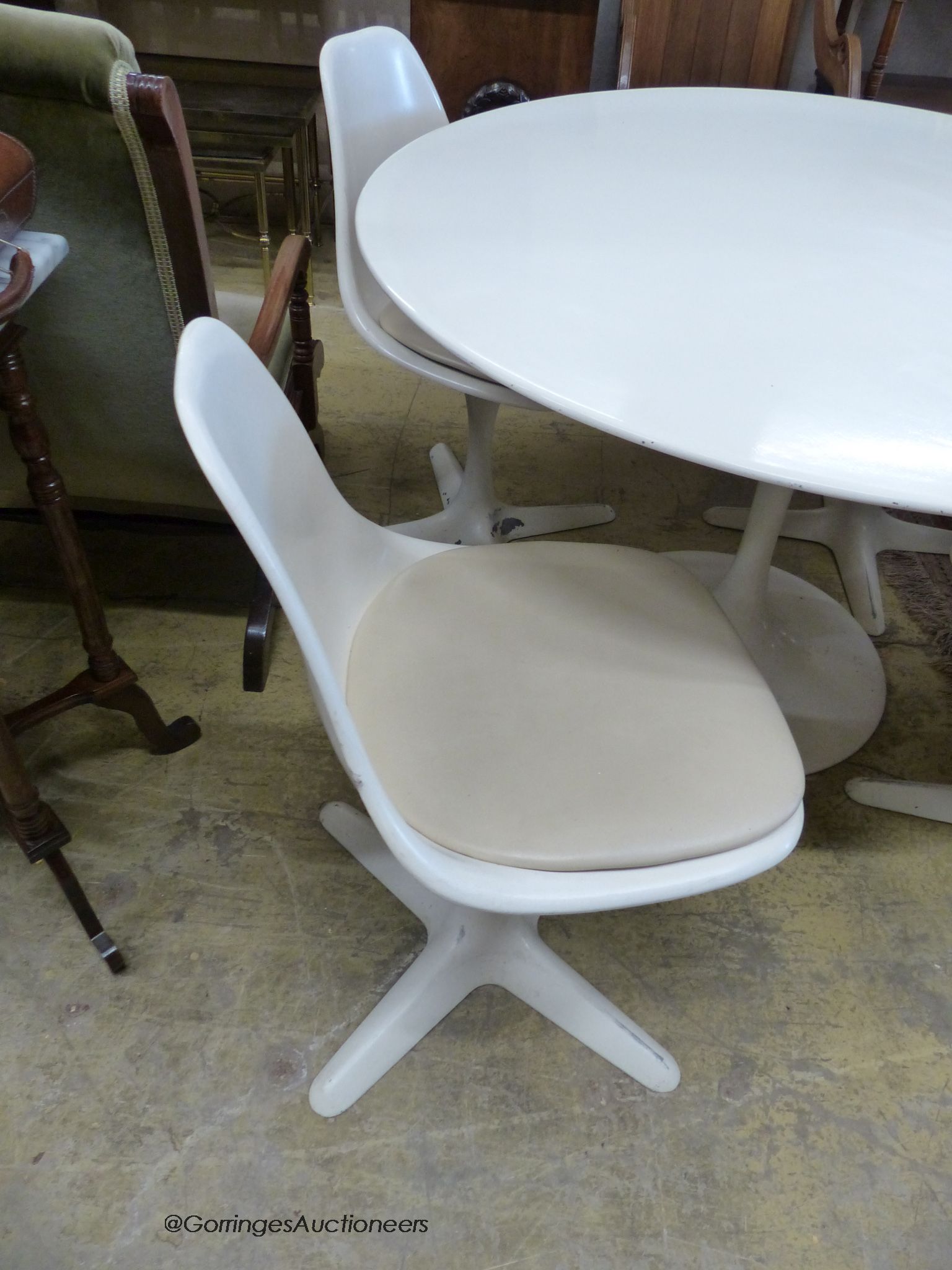 An Arkana tulip table, 120cm diameter, height 74cm and four tulip chairs